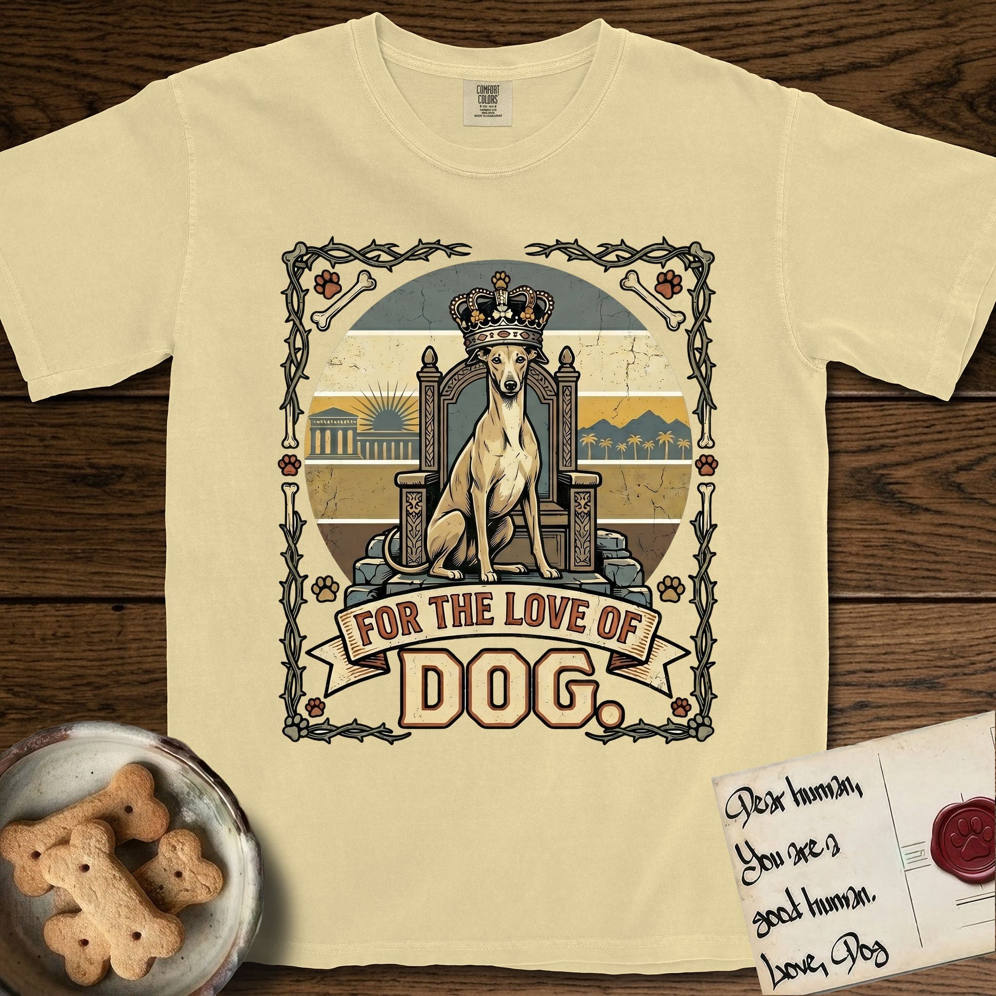 For the Love of Dog Whippet T-Shirt flat lay in Butter, featuring a vintage badge of a crowned Whippet seated on a throne.