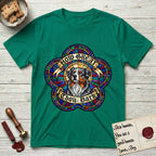 How Great Thou Bark Australian Shepherd T-Shirt flat lay in Kelly Green, featuring a full-color stained-glass saint window of a blue merle Australian Shepherd with one blue eye and one amber eye, haloed in golden light.