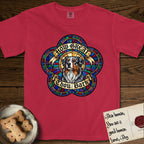 How Great Thou Bark Australian Shepherd T-Shirt flat lay in Red, featuring a full-color stained-glass saint window of a blue merle Australian Shepherd with one blue eye and one amber eye, haloed in golden light.