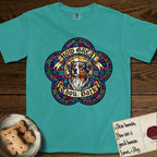 How Great Thou Bark Australian Shepherd T-Shirt flat lay in Seafoam, featuring a full-color stained-glass saint window of a blue merle Australian Shepherd with one blue eye and one amber eye, haloed in golden light.