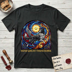 How Great Thou Bark Border Collie T-Shirt flat lay in Black, featuring a full-color stained-glass saint window of a winged Border Collie leaping after a glowing tennis ball, with a halo.