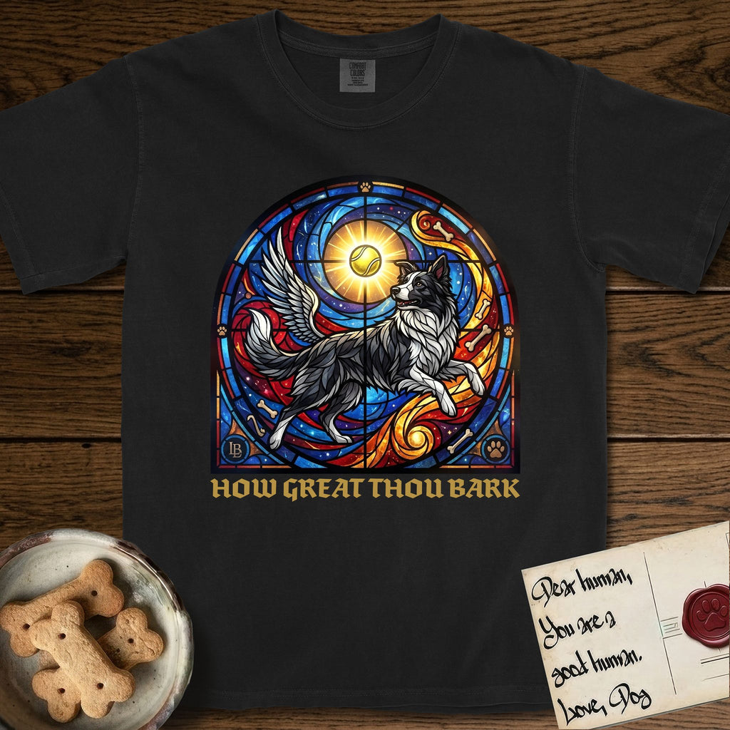 How Great Thou Bark Border Collie T-Shirt flat lay in Black, featuring a full-color stained-glass saint window of a winged Border Collie leaping after a glowing tennis ball, with a halo.