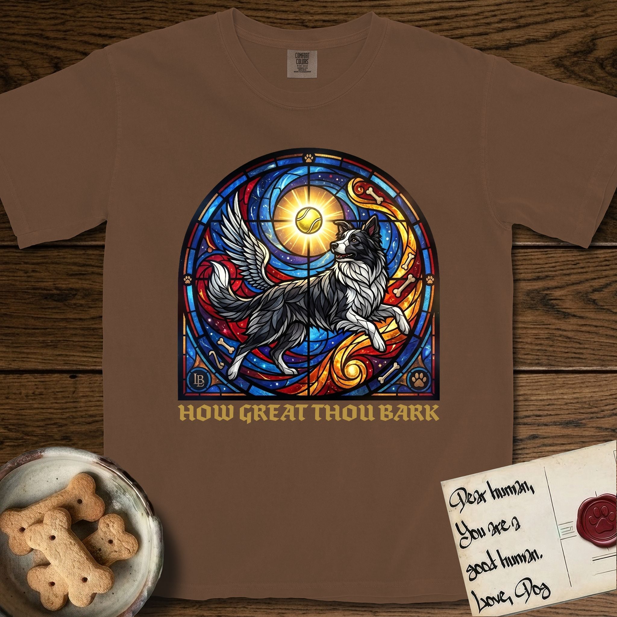 How Great Thou Bark Border Collie T-Shirt flat lay in Espresso, featuring a full-color stained-glass saint window of a winged Border Collie leaping after a glowing tennis ball, with a halo.