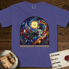 How Great Thou Bark Border Collie T-Shirt flat lay in Grape, featuring a full-color stained-glass saint window of a winged Border Collie leaping after a glowing tennis ball, with a halo.
