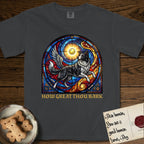 How Great Thou Bark Border Collie T-Shirt flat lay in Graphite, featuring a full-color stained-glass saint window of a winged Border Collie leaping after a glowing tennis ball, with a halo.