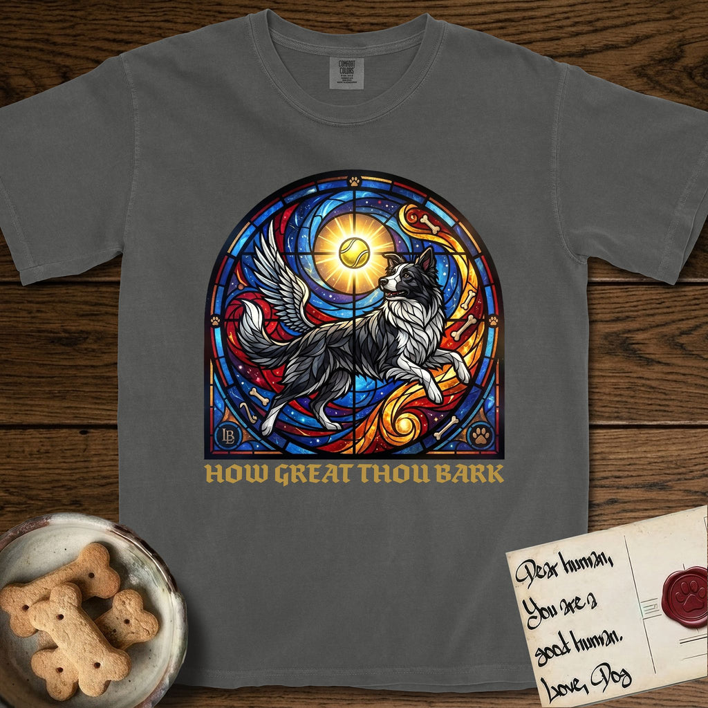 How Great Thou Bark Border Collie T-Shirt flat lay in Pepper, featuring a full-color stained-glass saint window of a winged Border Collie leaping after a glowing tennis ball, with a halo.