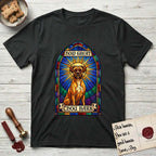 How Great Thou Bark Boxer T-Shirt flat lay in Black, featuring a full-color stained-glass saint window of a Boxer seated in warm golden light with a halo.