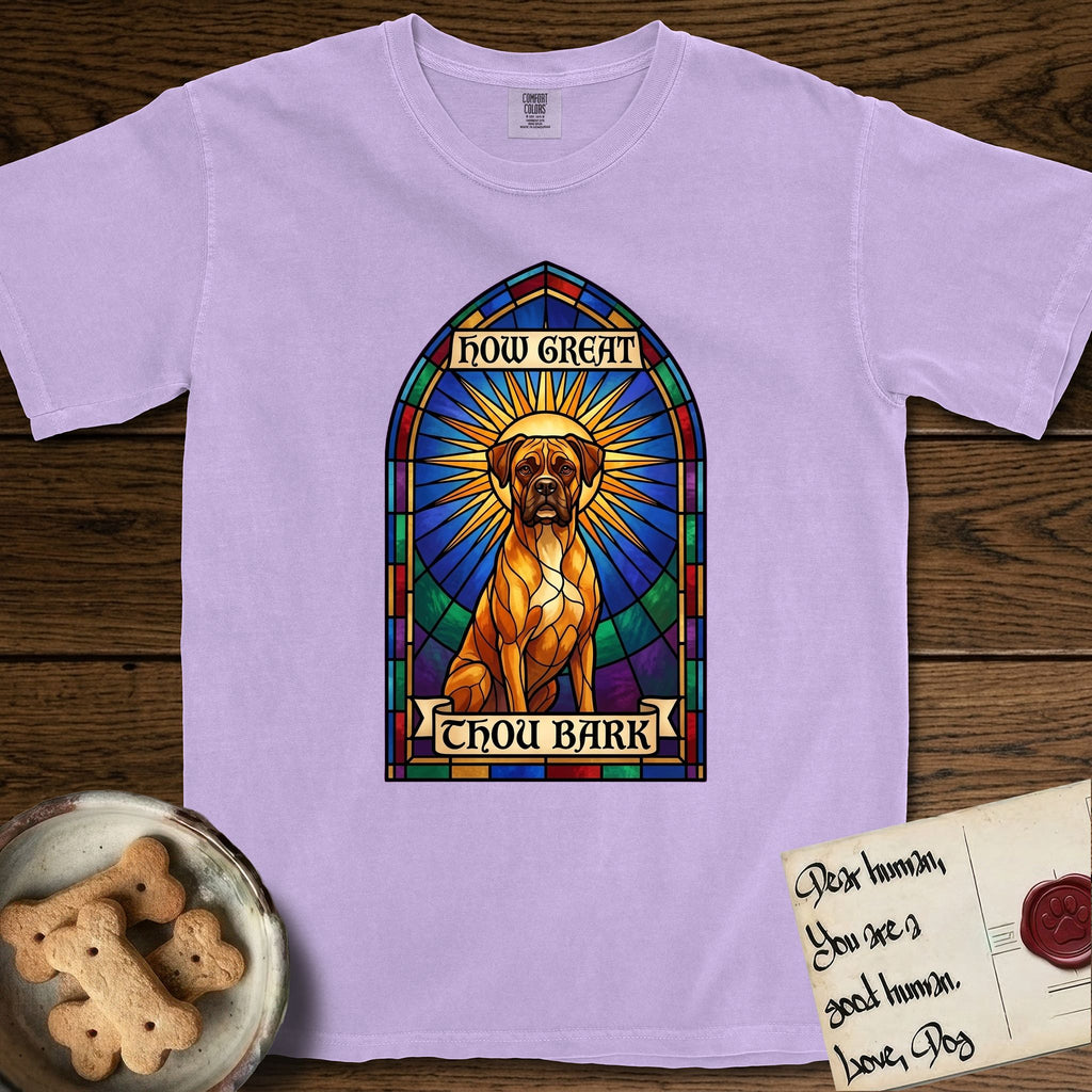 How Great Thou Bark Boxer T-Shirt flat lay in Orchid, featuring a full-color stained-glass saint window of a Boxer seated in warm golden light with a halo.
