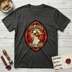 How Great Thou Bark Bull Terrier T-Shirt flat lay in Charcoal, featuring a full-color stained-glass saint window of a brown and white Bull Terrier with head raised and mouth open mid-howl, haloed in golden light.