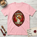 How Great Thou Bark Bull Terrier T-Shirt flat lay in Light Pink, featuring a full-color stained-glass saint window of a brown and white Bull Terrier with head raised and mouth open mid-howl, haloed in golden light.
