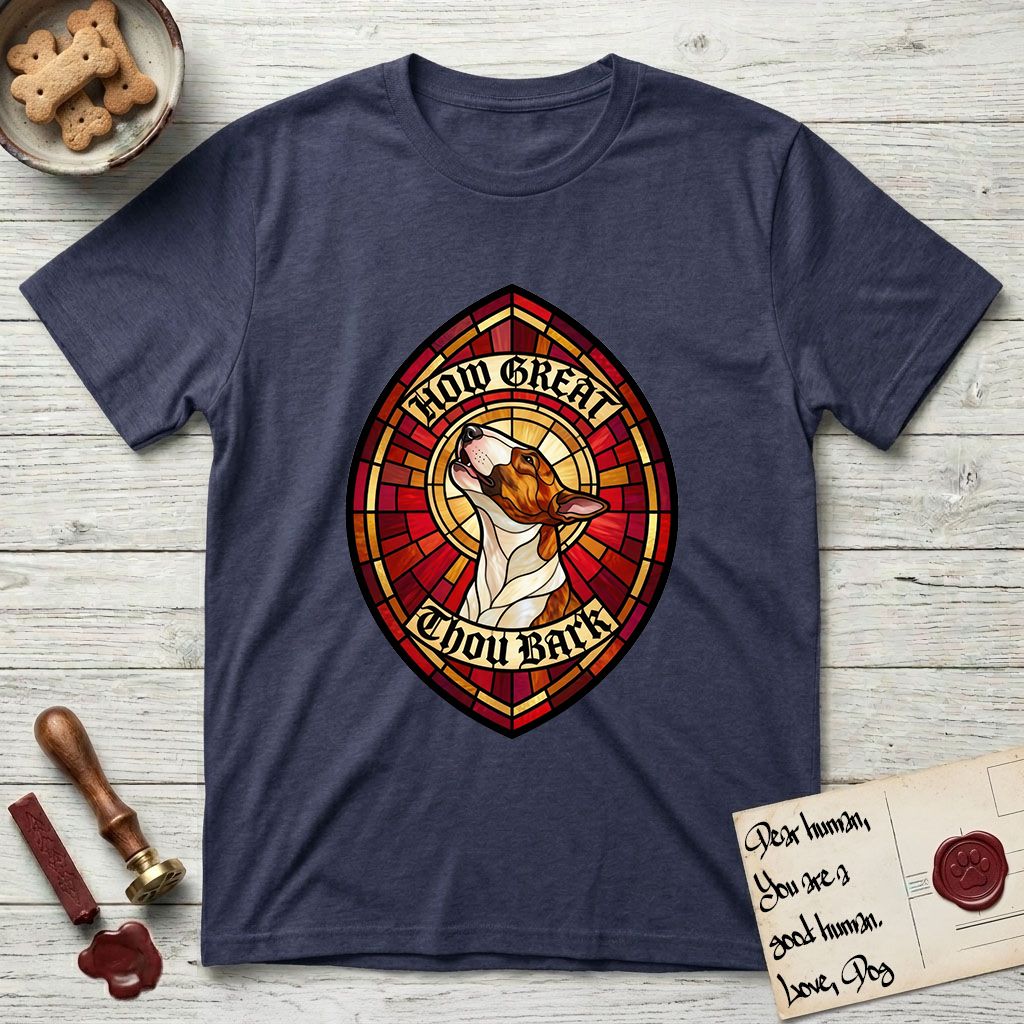 How Great Thou Bark Bull Terrier T-Shirt flat lay in Navy, featuring a full-color stained-glass saint window of a brown and white Bull Terrier with head raised and mouth open mid-howl, haloed in golden light.