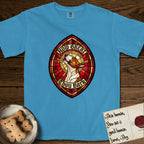 How Great Thou Bark Bull Terrier T-Shirt flat lay in Royal Caribe, featuring a full-color stained-glass saint window of a brown and white Bull Terrier with head raised and mouth open mid-howl, haloed in golden light.