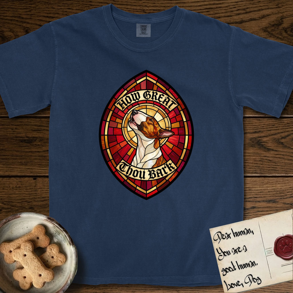 How Great Thou Bark Bull Terrier T-Shirt flat lay in True Navy, featuring a full-color stained-glass saint window of a brown and white Bull Terrier with head raised and mouth open mid-howl, haloed in golden light.