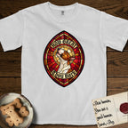 How Great Thou Bark Bull Terrier T-Shirt flat lay in White, featuring a full-color stained-glass saint window of a brown and white Bull Terrier with head raised and mouth open mid-howl, haloed in golden light.