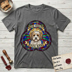 How Great Thou Bark Coton de Tulear T-Shirt flat lay in Dark Heather, featuring a full-color stained-glass saint window of a sable and white Coton de Tulear facing forward, haloed in golden light.