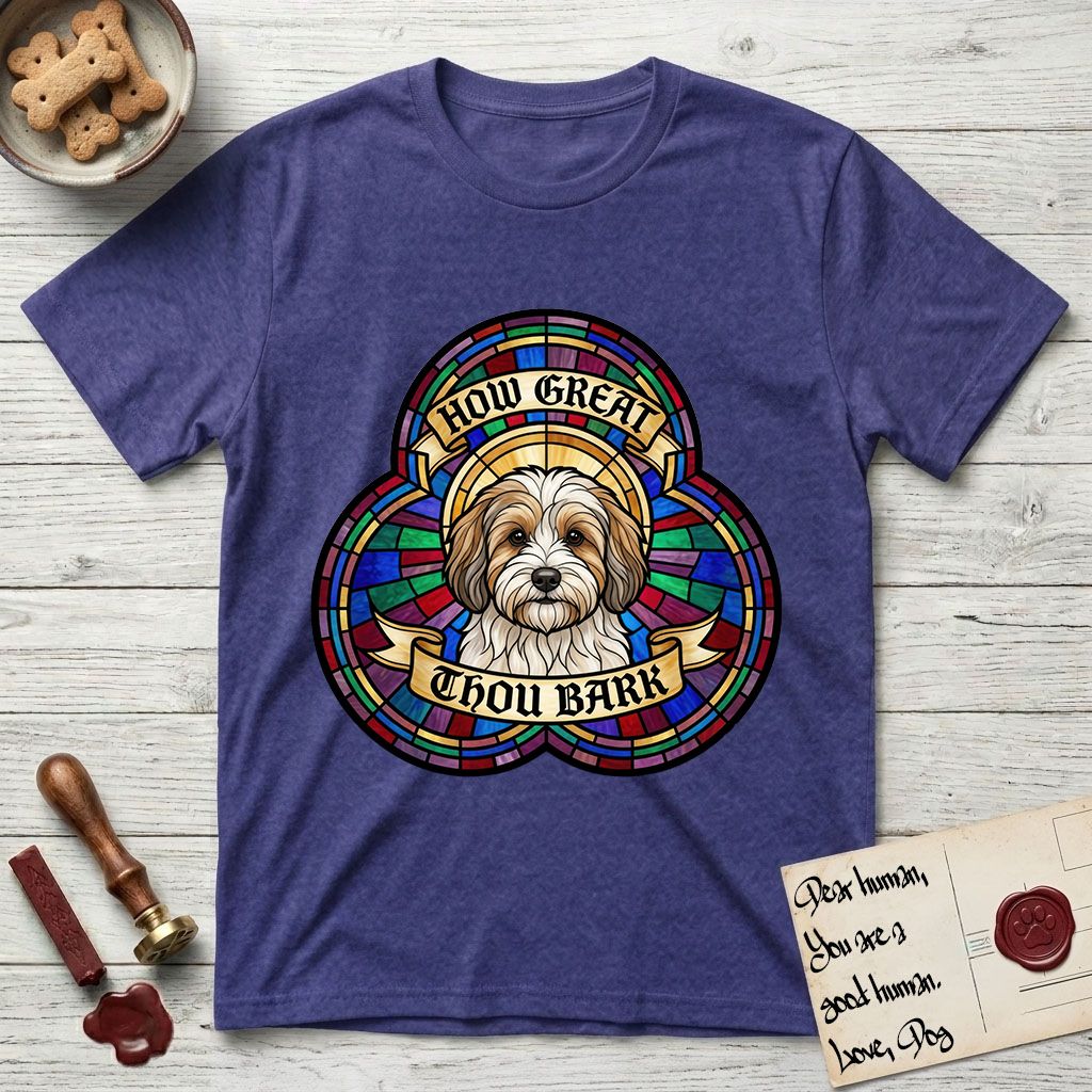 How Great Thou Bark Coton de Tulear T-Shirt flat lay in Metro Blue, featuring a full-color stained-glass saint window of a sable and white Coton de Tulear facing forward, haloed in golden light.