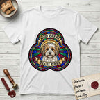 How Great Thou Bark Coton de Tulear T-Shirt flat lay in White, featuring a full-color stained-glass saint window of a sable and white Coton de Tulear facing forward, haloed in golden light.