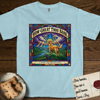 How Great Thou Bark Golden Retriever T-Shirt flat lay in Chambray, featuring a full-color stained-glass saint window of a Golden Retriever standing on a mountain with light breaking through the clouds and a halo.