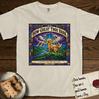 How Great Thou Bark Golden Retriever T-Shirt flat lay in Ivory, featuring a full-color stained-glass saint window of a Golden Retriever standing on a mountain with light breaking through the clouds and a halo.