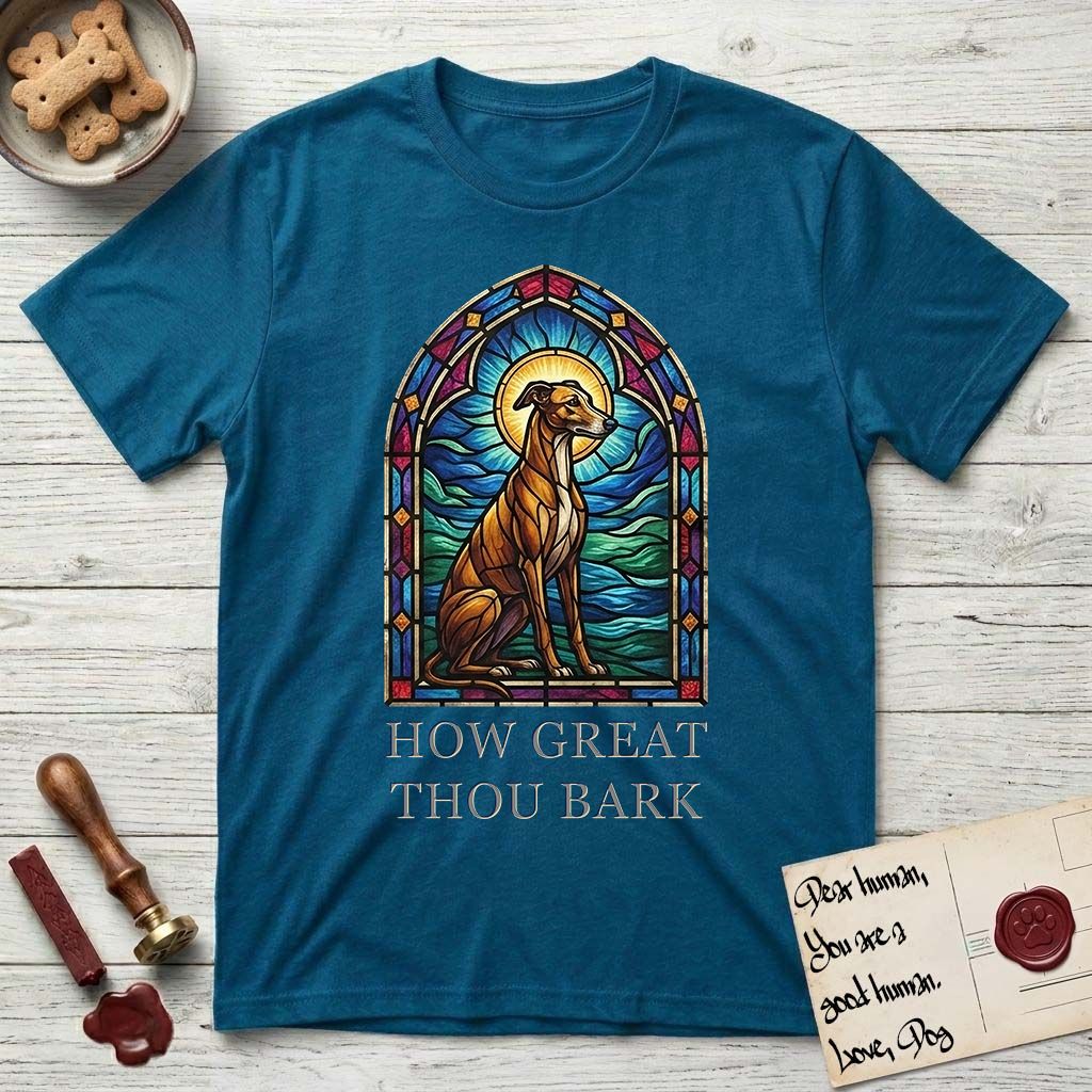 How Great Thou Bark Greyhound T-Shirt flat lay in Antique Sapphire, featuring a full-color stained-glass saint window of a Greyhound sitting in stillness, with a halo.