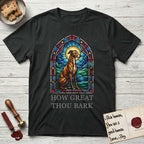 How Great Thou Bark Greyhound T-Shirt flat lay in Black, featuring a full-color stained-glass saint window of a Greyhound sitting in stillness, with a halo.