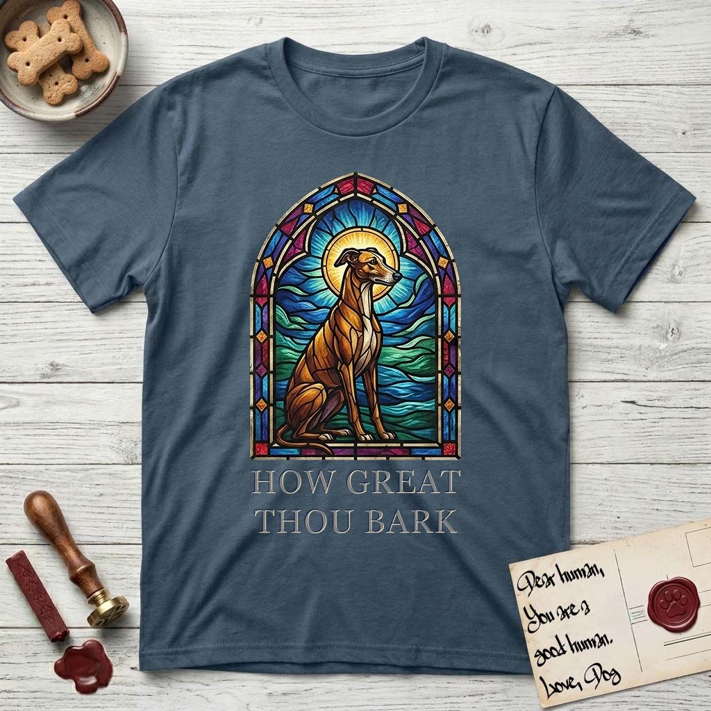 How Great Thou Bark Greyhound T-Shirt flat lay in Indigo Blue, featuring a full-color stained-glass saint window of a Greyhound sitting in stillness, with a halo.