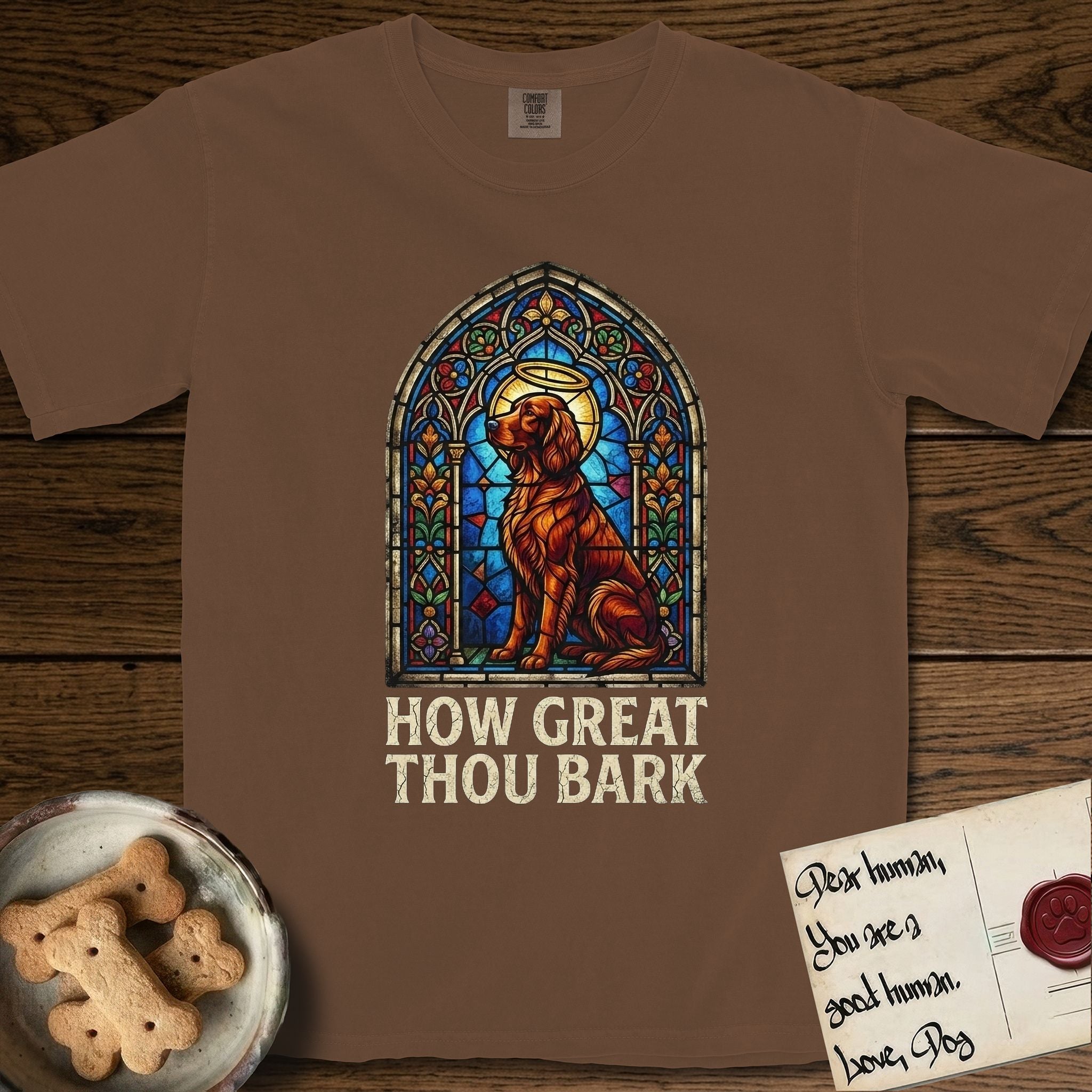 How Great Thou Bark Irish Setter T-Shirt flat lay in Espresso, featuring a full-color stained-glass saint window of an Irish Setter seated and gazing up into the light, with a halo.