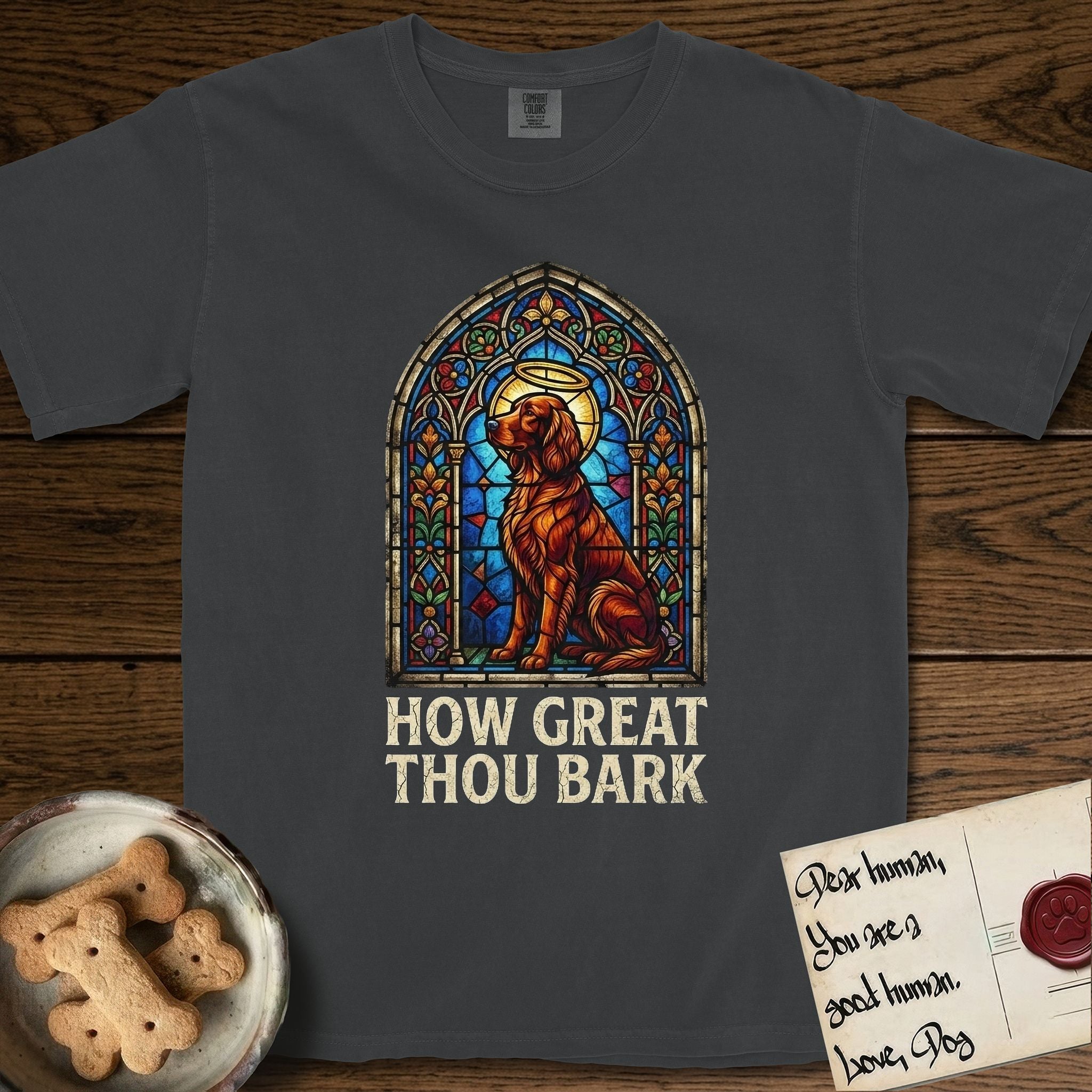 How Great Thou Bark Irish Setter T-Shirt flat lay in Graphite, featuring a full-color stained-glass saint window of an Irish Setter seated and gazing up into the light, with a halo.