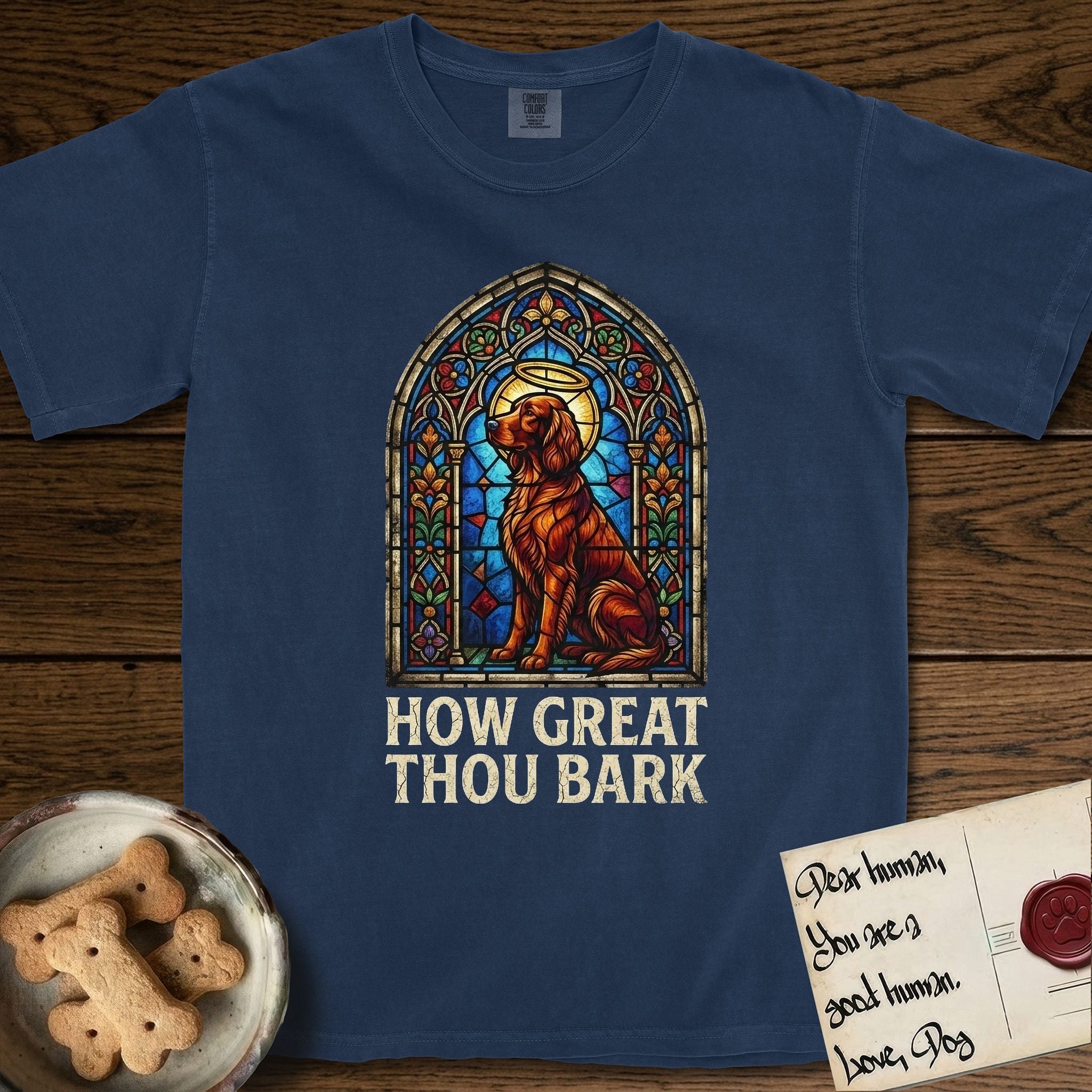 How Great Thou Bark Irish Setter T-Shirt flat lay in True Navy, featuring a full-color stained-glass saint window of an Irish Setter seated and gazing up into the light, with a halo.