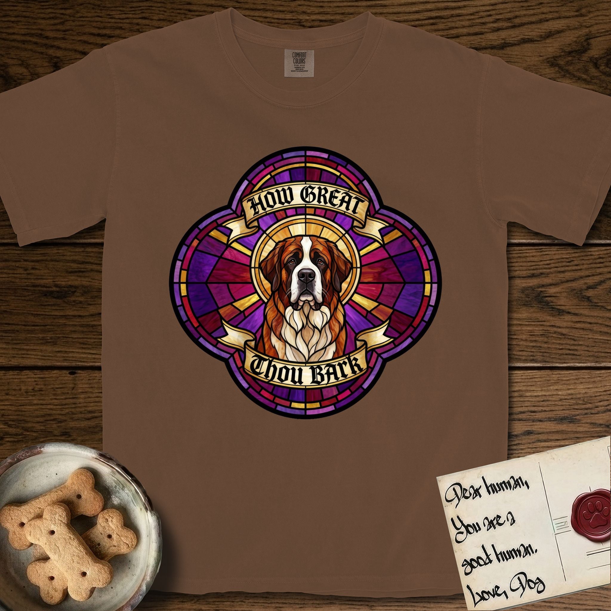 How Great Thou Bark Saint Bernard T-Shirt flat lay in Espresso, featuring a full-color stained-glass saint window of a red and white Saint Bernard facing forward, haloed in golden light.