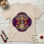 How Great Thou Bark Saint Bernard T-Shirt flat lay in Sand, featuring a full-color stained-glass saint window of a red and white Saint Bernard facing forward, haloed in golden light.