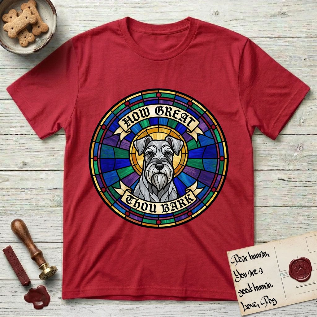 How Great Thou Bark Schnauzer T-Shirt flat lay in Cherry Red, featuring a full-color stained-glass saint window of a salt-and-pepper Schnauzer with bushy eyebrows and beard, haloed in golden light.
