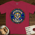 How Great Thou Bark Schnauzer T-Shirt flat lay in Chili, featuring a full-color stained-glass saint window of a salt-and-pepper Schnauzer with bushy eyebrows and beard, haloed in golden light.