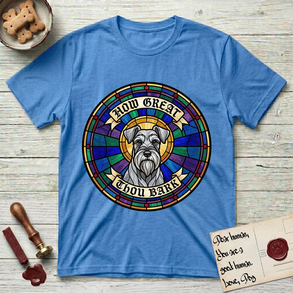 How Great Thou Bark Schnauzer T-Shirt flat lay in Heather Sapphire, featuring a full-color stained-glass saint window of a salt-and-pepper Schnauzer with bushy eyebrows and beard, haloed in golden light.