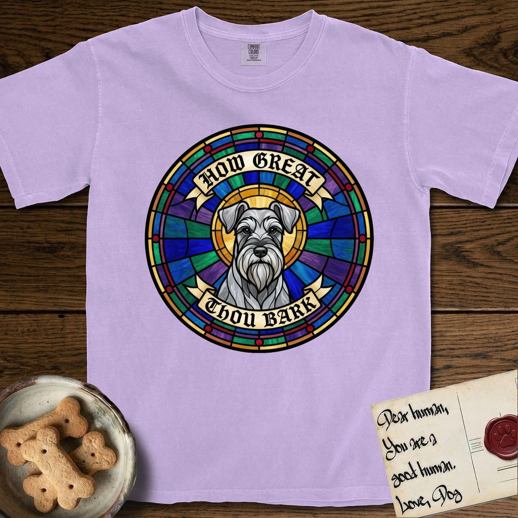 How Great Thou Bark Schnauzer T-Shirt flat lay in Orchid, featuring a full-color stained-glass saint window of a salt-and-pepper Schnauzer with bushy eyebrows and beard, haloed in golden light.