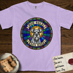 How Great Thou Bark Schnauzer T-Shirt flat lay in Orchid, featuring a full-color stained-glass saint window of a salt-and-pepper Schnauzer with bushy eyebrows and beard, haloed in golden light.