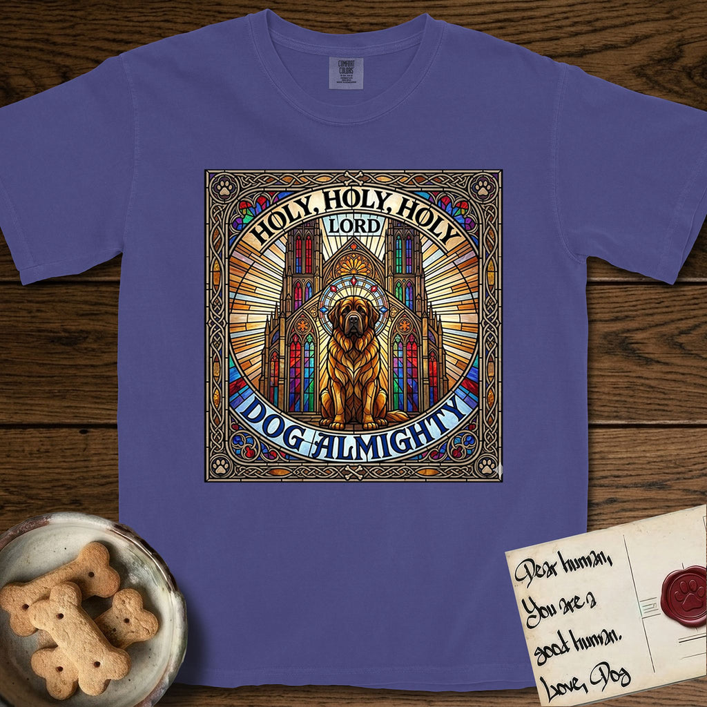 Holy Holy Holy Newfoundland T-Shirt flat lay in Grape, featuring a gothic stained-glass window in jewel tones with a Newfoundland at center, Celtic knotwork border, corner paw prints, and the words Holy Holy Holy and Dog Almighty.