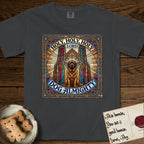 Holy Holy Holy Newfoundland T-Shirt flat lay in Graphite, featuring a gothic stained-glass window in jewel tones with a Newfoundland at center, Celtic knotwork border, corner paw prints, and the words Holy Holy Holy and Dog Almighty.