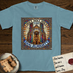 Holy Holy Holy Newfoundland T-Shirt flat lay in Ice Blue, featuring a gothic stained-glass window in jewel tones with a Newfoundland at center, Celtic knotwork border, corner paw prints, and the words Holy Holy Holy and Dog Almighty.