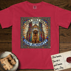 Holy Holy Holy Newfoundland T-Shirt flat lay in Red, featuring a gothic stained-glass window in jewel tones with a Newfoundland at center, Celtic knotwork border, corner paw prints, and the words Holy Holy Holy and Dog Almighty.