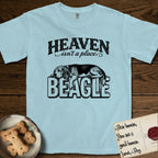 Heaven Isn't a Place Beagle T-Shirt flat lay in Chambray, featuring Black ink engraving illustration of a tricolor Beagle asleep on top of the giant carved block letters BEAGLE, under the lettering HEAVEN isn't a place..
