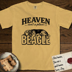 Heaven Isn't a Place Beagle T-Shirt flat lay in Mustard, featuring Black ink engraving illustration of a tricolor Beagle asleep on top of the giant carved block letters BEAGLE, under the lettering HEAVEN isn't a place..