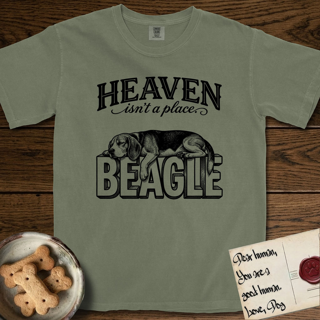 Heaven Isn't a Place Beagle T-Shirt flat lay in Sage, featuring Black ink engraving illustration of a tricolor Beagle asleep on top of the giant carved block letters BEAGLE, under the lettering HEAVEN isn't a place..