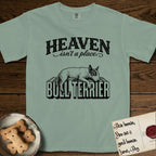 Heaven Isn't a Place Bull Terrier T-Shirt flat lay in Bay, featuring Black ink engraving illustration of a Bull Terrier with a dark patch over one eye asleep on top of the giant carved block letters BULL TERRIER, under the lettering HEAVEN isn't a place..