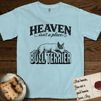 Heaven Isn't a Place Bull Terrier T-Shirt flat lay in Chambray, featuring Black ink engraving illustration of a Bull Terrier with a dark patch over one eye asleep on top of the giant carved block letters BULL TERRIER, under the lettering HEAVEN isn't a place..