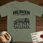 Heaven Isn't a Place Cairn Terrier T-Shirt flat lay in Sage, featuring Black ink engraving illustration of a shaggy Cairn Terrier asleep on top of the giant carved block letters CAIRN, under the lettering HEAVEN isn't a place..