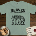 Heaven Isn't a Place Corgi T-Shirt flat lay in Bay, featuring Black ink engraving illustration of a Corgi with a long fluffy tail asleep on top of the giant carved block letters CORGI, under the lettering HEAVEN isn't a place..