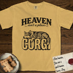 Heaven Isn't a Place Corgi T-Shirt flat lay in Mustard, featuring Black ink engraving illustration of a Corgi with a long fluffy tail asleep on top of the giant carved block letters CORGI, under the lettering HEAVEN isn't a place..