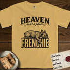 Heaven Isn't a Place French Bulldog T-Shirt flat lay in Mustard, featuring Black ink engraving illustration of a brindle French Bulldog asleep on top of the giant carved block letters FRENCHIE, under the lettering HEAVEN isn't a place..