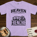 Heaven Isn't a Place French Bulldog T-Shirt flat lay in Orchid, featuring Black ink engraving illustration of a brindle French Bulldog asleep on top of the giant carved block letters FRENCHIE, under the lettering HEAVEN isn't a place..